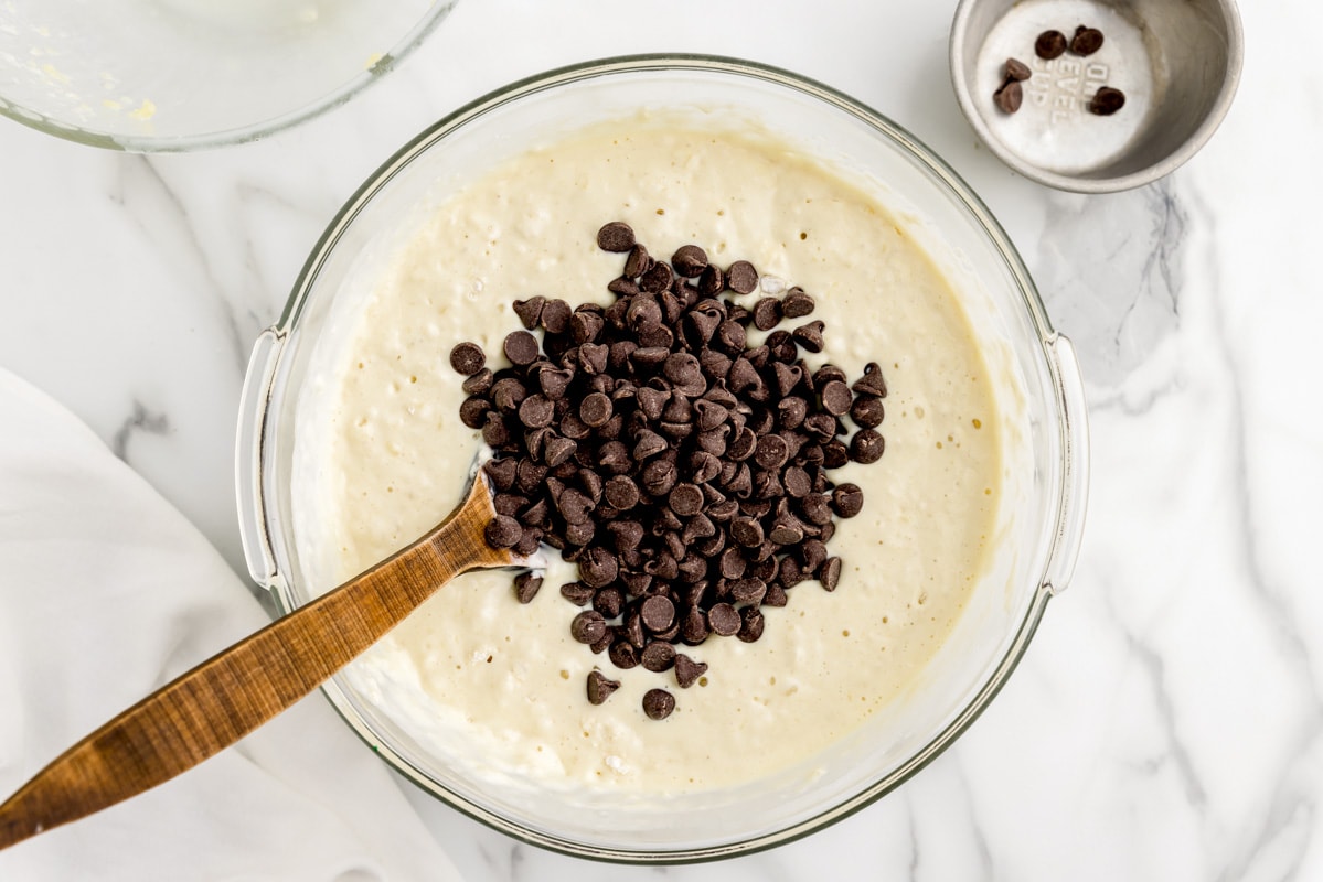 Folding chocolate chips into the pancake batter.