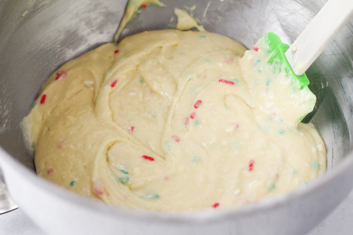 Sprinkles mixed into Christmas cupcake batter.