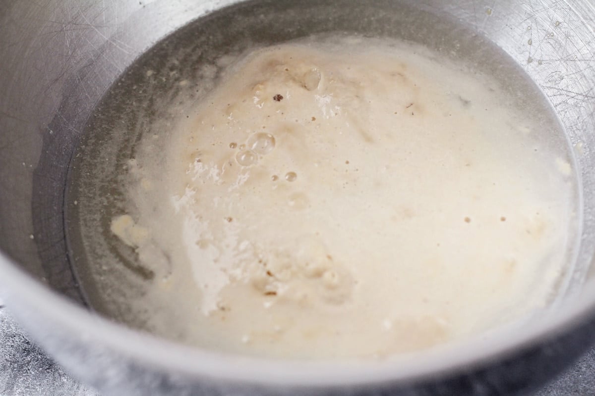 Blooming yeast in a metal bowl.