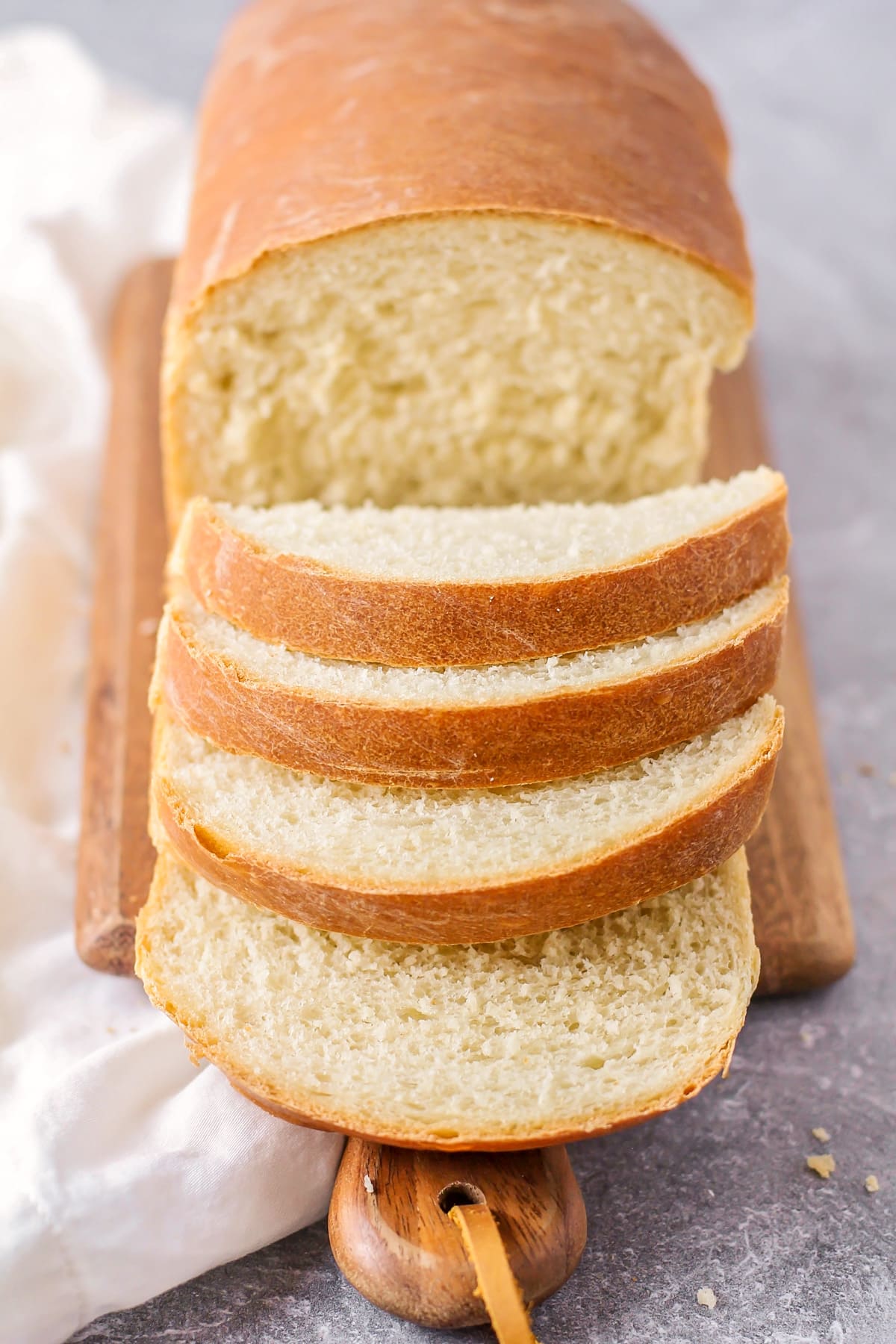 Sliced white bread on a cutting board.