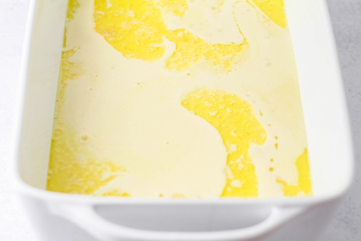 Melted butter in a white baking dish.