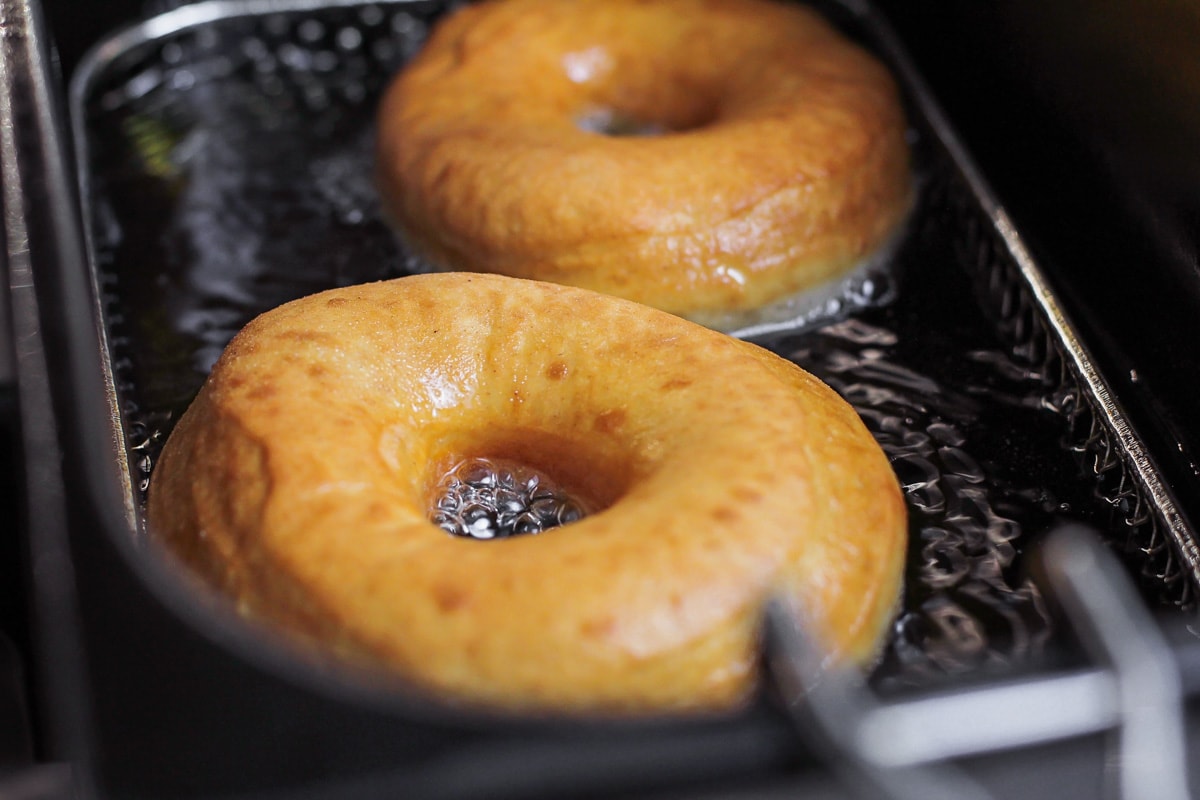 Frying homemade donuts in hot oil.