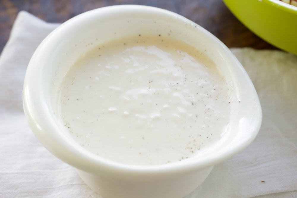 Dressing in a white bowl ready for using.