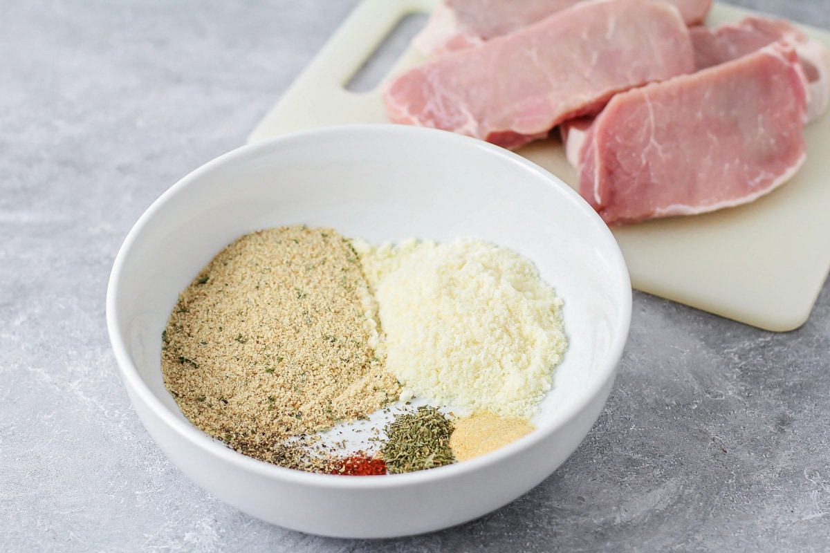 A bowl of seasonings for coating pork chops.