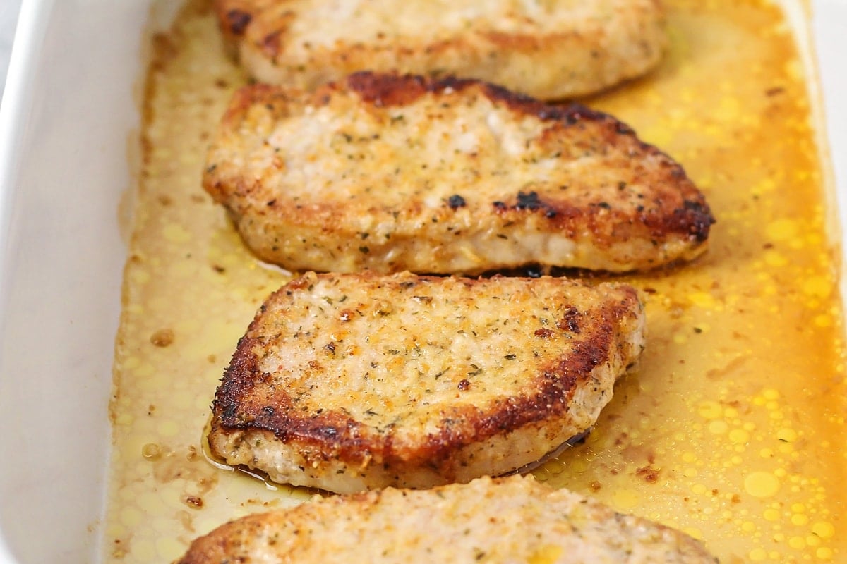 Baking up parmesan crusted pork chops in a baking dish.