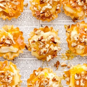 Brie Phyllo Tarts are easy bite size appetizers with flaky phyllo cups, creamy Brie, apricot preserves, and chopped pecans.