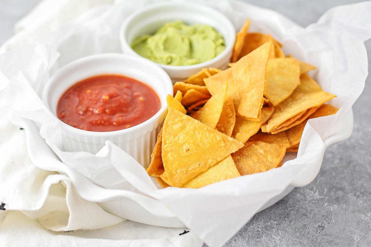 Homemade tortilla chips made from corn tortillas in basket.