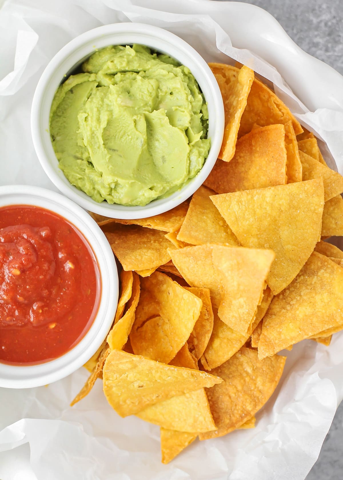 Homemade Corn Tortilla Chips recipe close up image with salsa and guac.