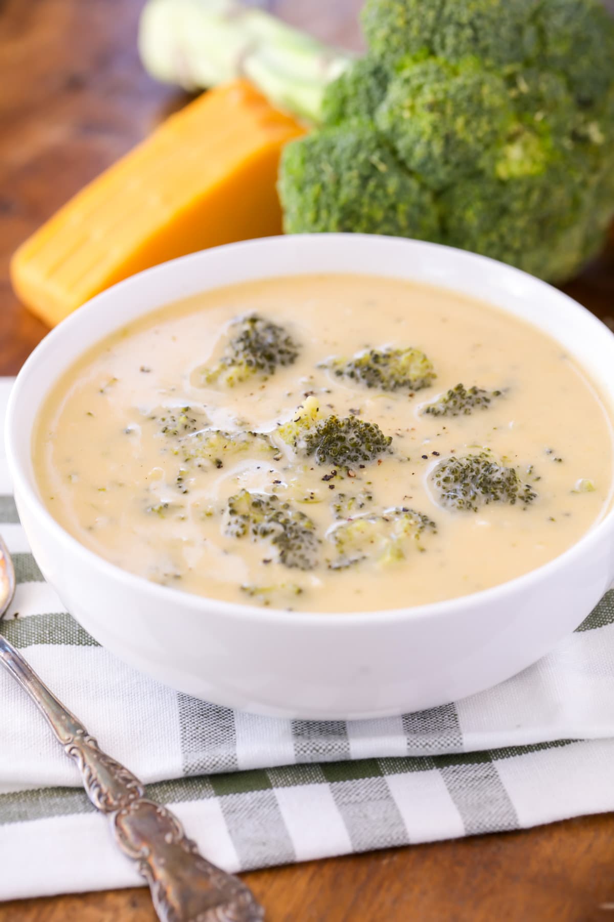 Best Broccoli cheddar soup in white bowl close up image.
