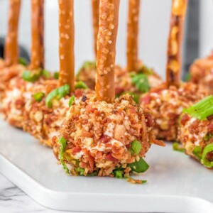 Cheese ball bites on a white tray.