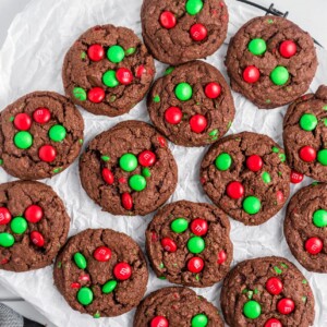 Chocolate Christmas cookies on a lined baking sheet.