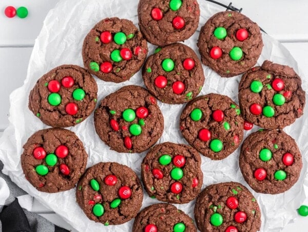 Chocolate Christmas cookies on a lined baking sheet.