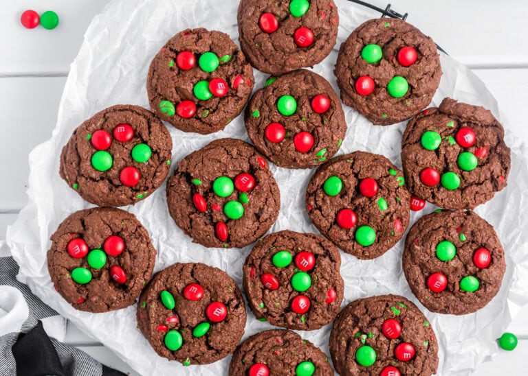 Chocolate Christmas cookies on a lined baking sheet.