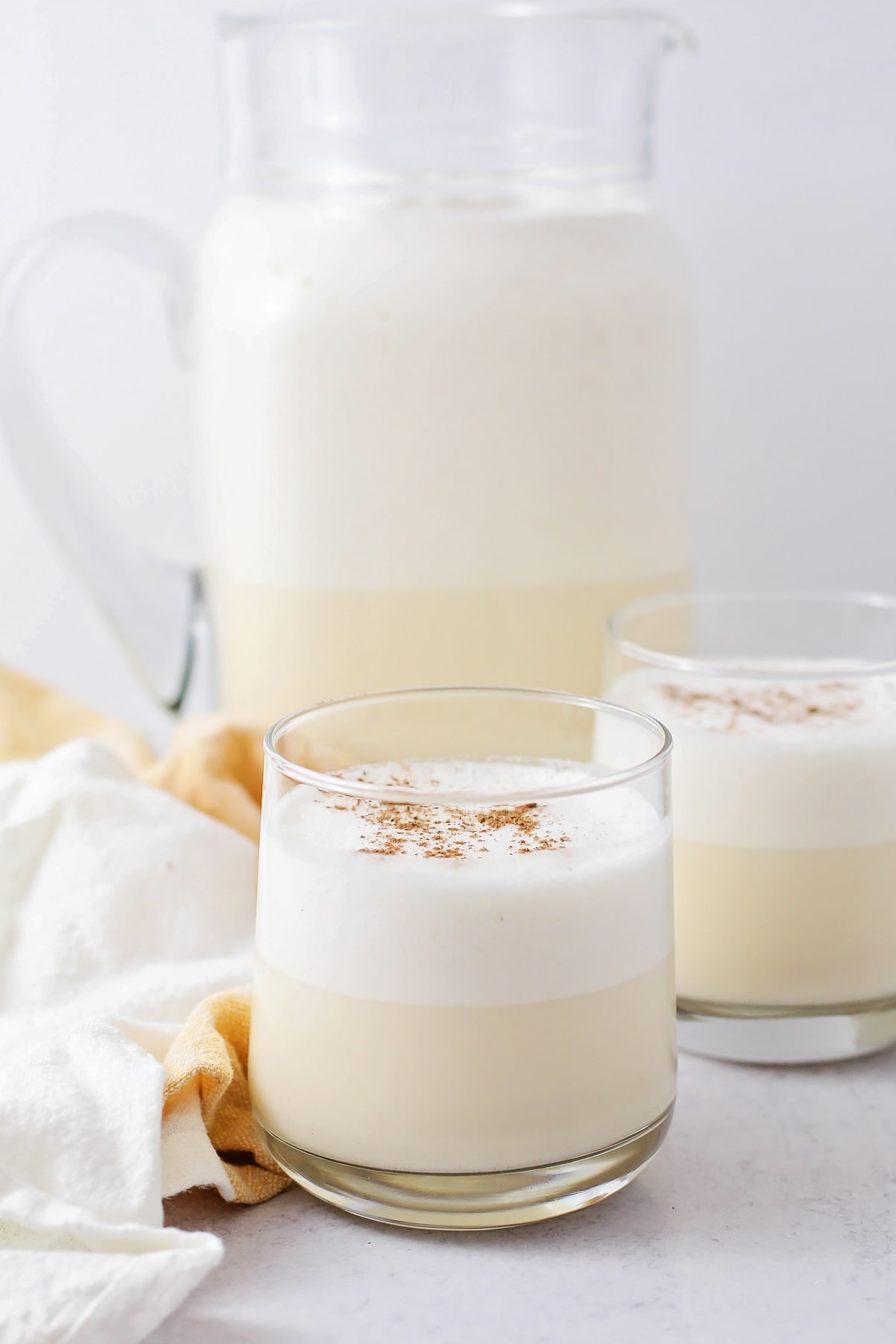 Homemade eggnog recipe served in a glass topped with nutmeg.