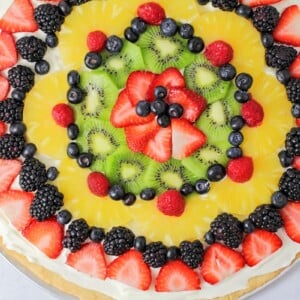 Top view of a fruit pizza covered in fresh fruit.