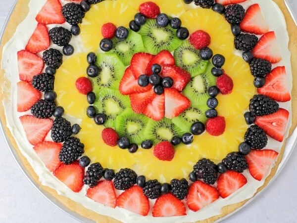 Top view of a fruit pizza covered in fresh fruit.