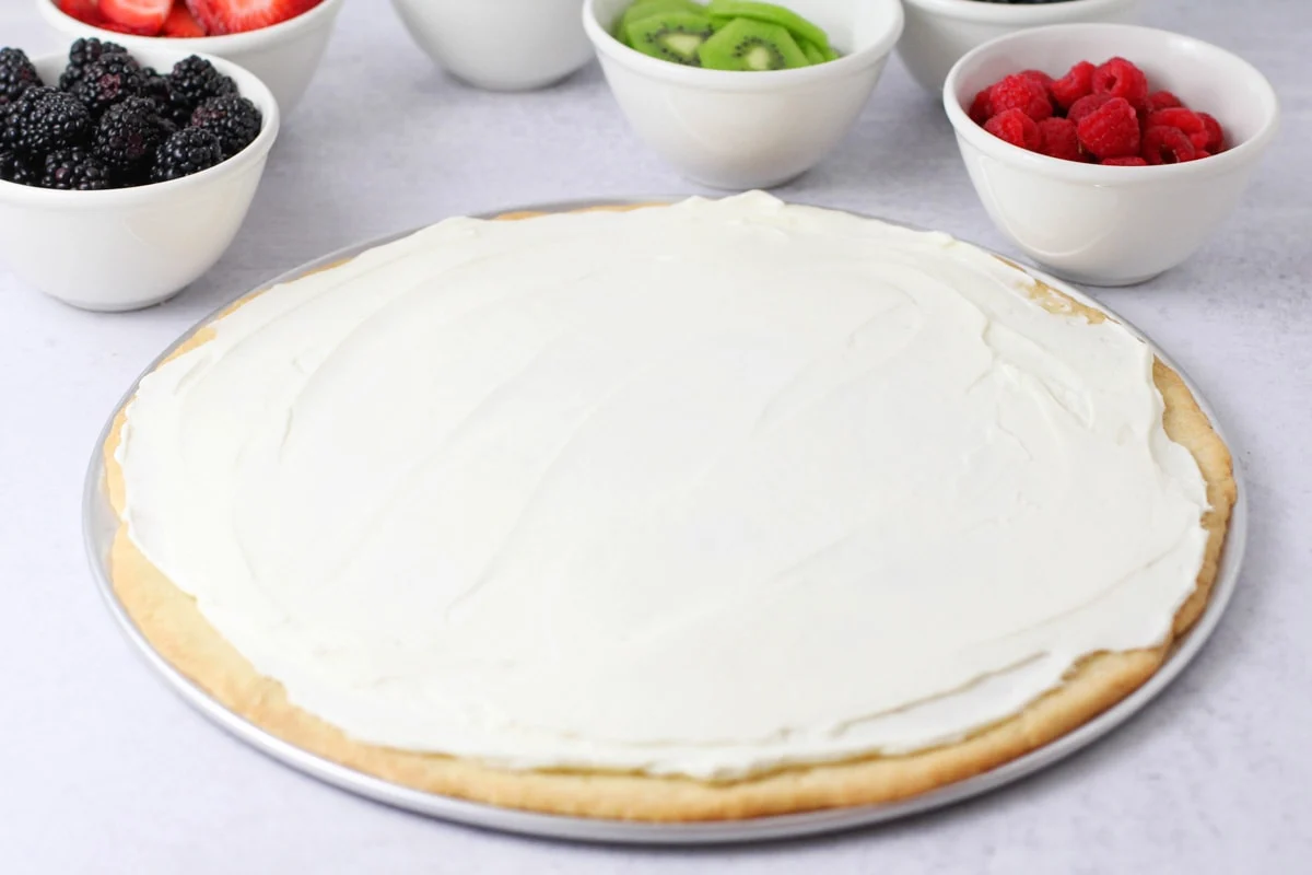 Creamy frosting spread on sugar cookie base.