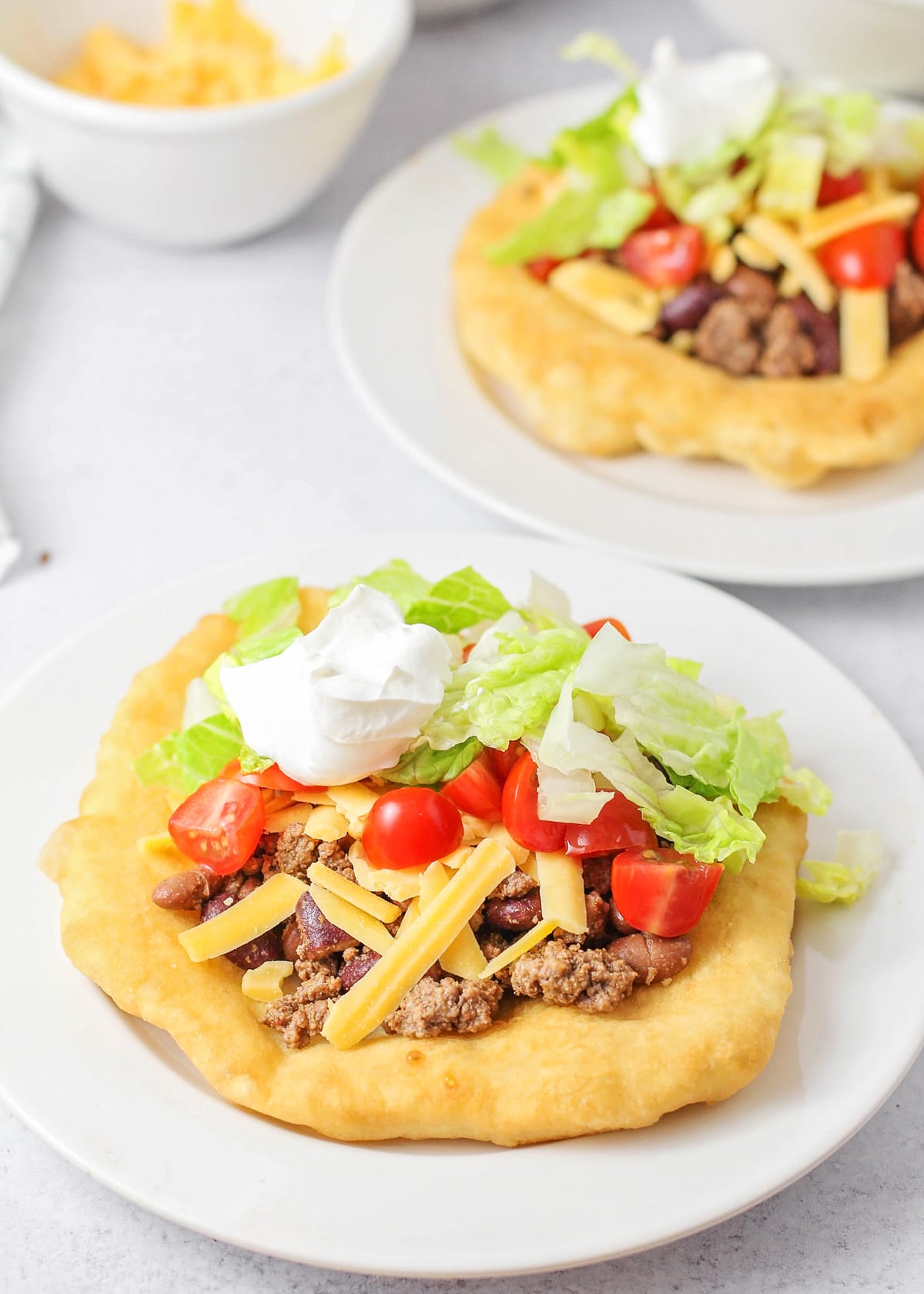 Fry bread served with meat, beans, cheese, lettuce, and sour cream.