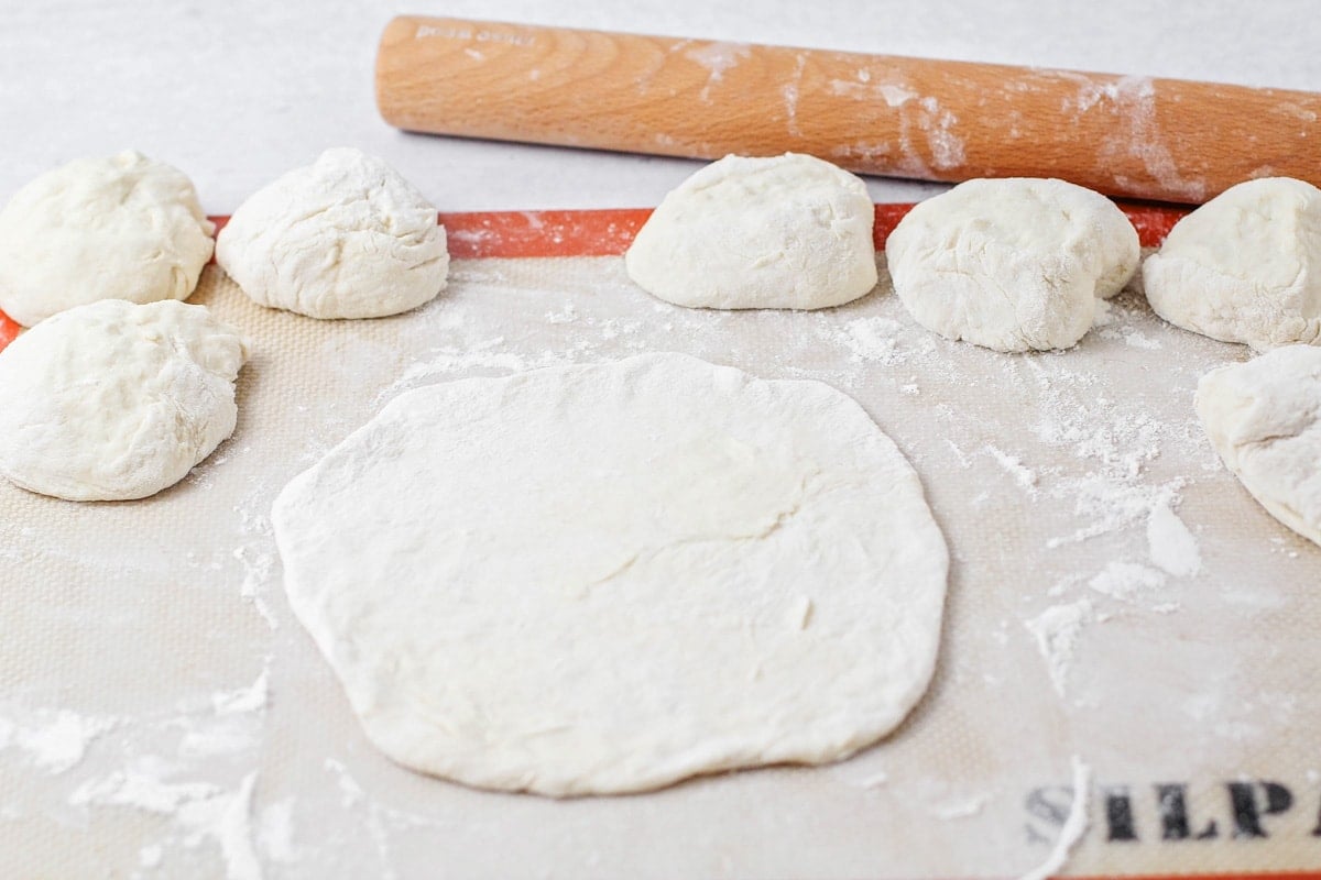 Rolling Indian fry bread dough balls for frying.