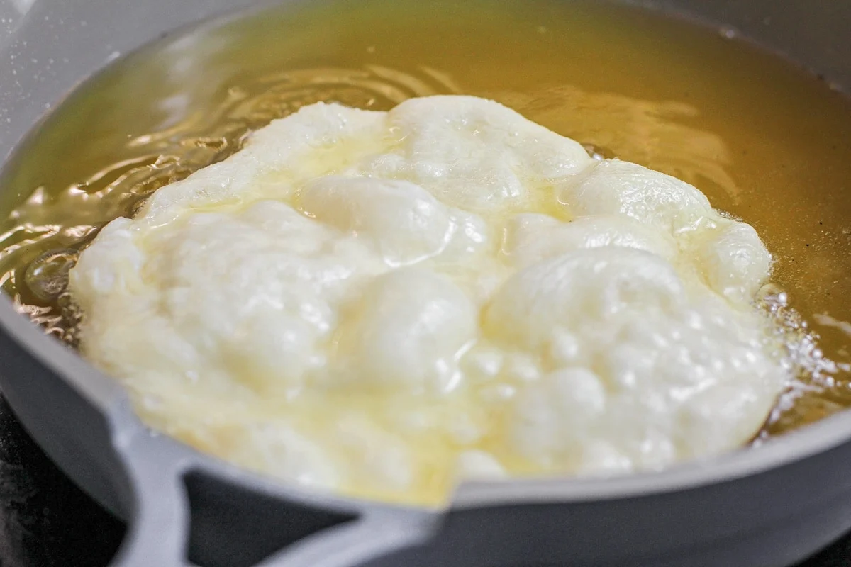 Frying up a Navajo Taco fry bread in oil.