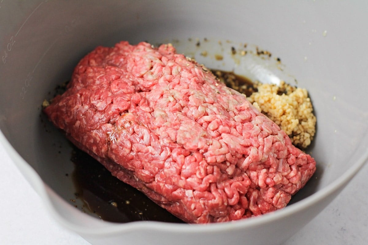 Mixing the meat for the best homemade hamburger recipe.