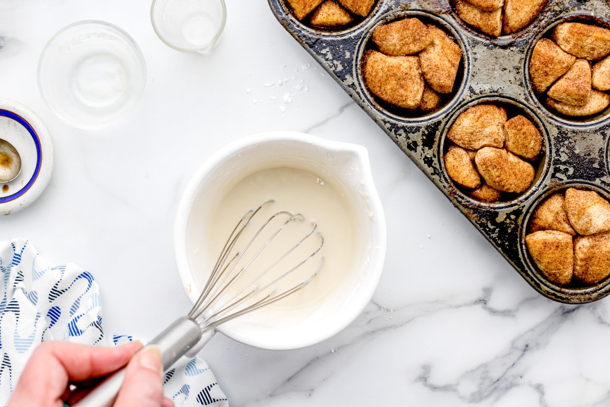 Whisking the glaze for monkey bread muffins.