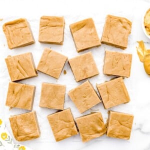Squares of peanut butter fudge on a kitchen counter.