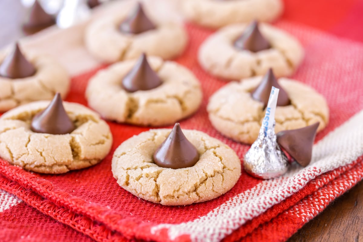Peanut Butter Kiss Cookies on a red dish towel.