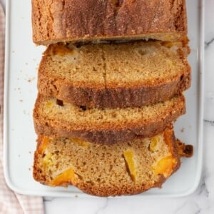 Sliced peach bread recipe on a cutting board.