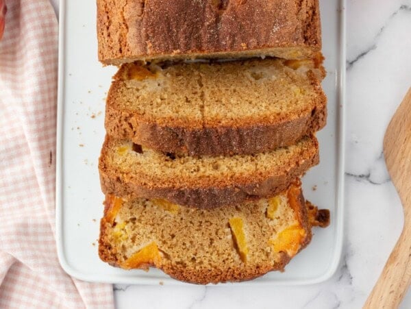 Sliced peach bread recipe on a cutting board.