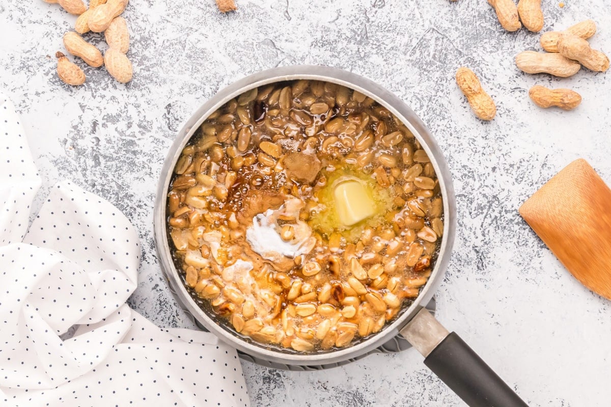 Adding peanuts and butter to the pot.