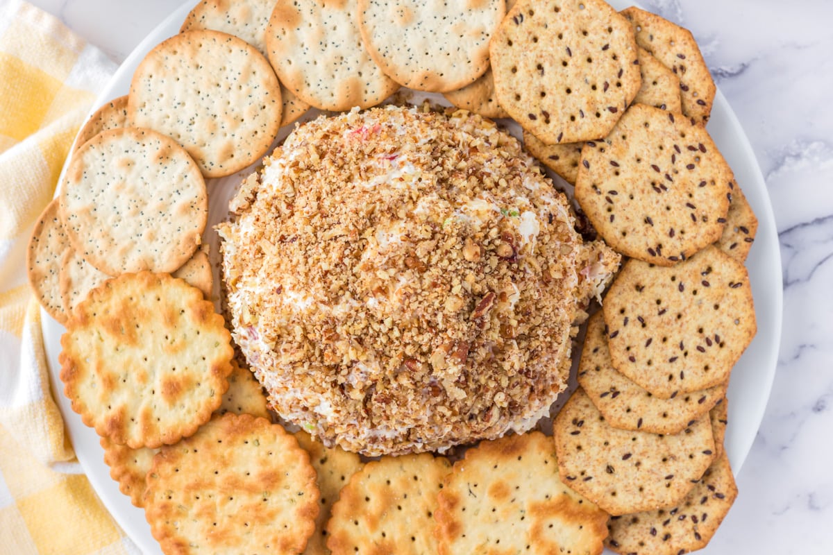 Pineapple Cheese ball surrounded with a variety of crackers.