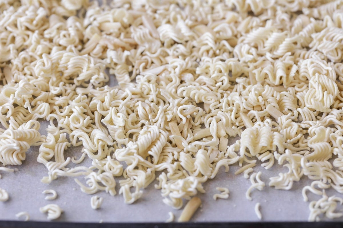 Ramen noodles crushed on baking sheet for Ramen noodle salad.