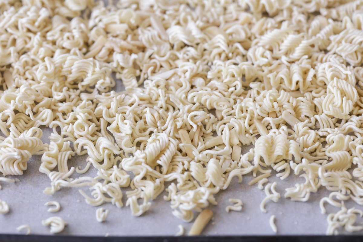 Ramen noodles crushed on baking sheet for Ramen noodle salad.