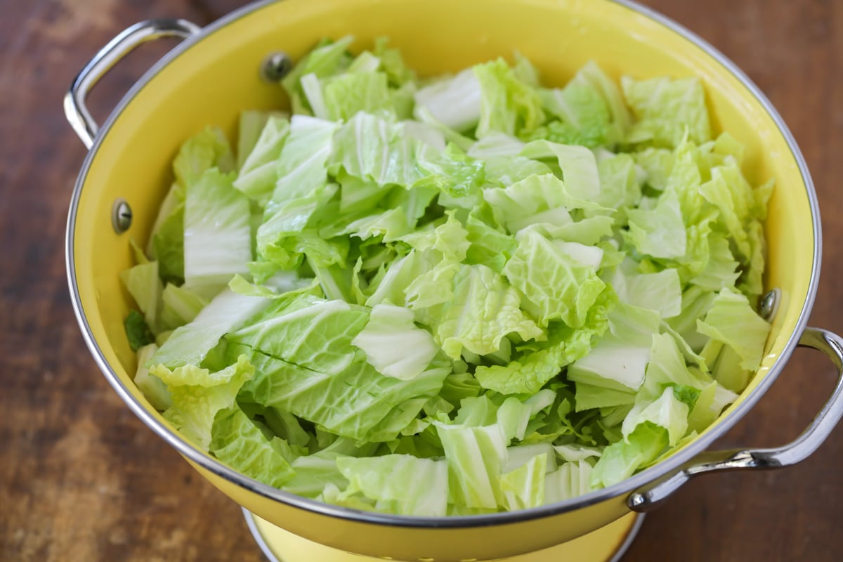 Chopped napa salad in colander for Ramen Noodle Salad.