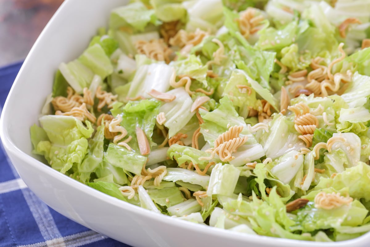 Ramen noodle salad in white bowl, close up image.