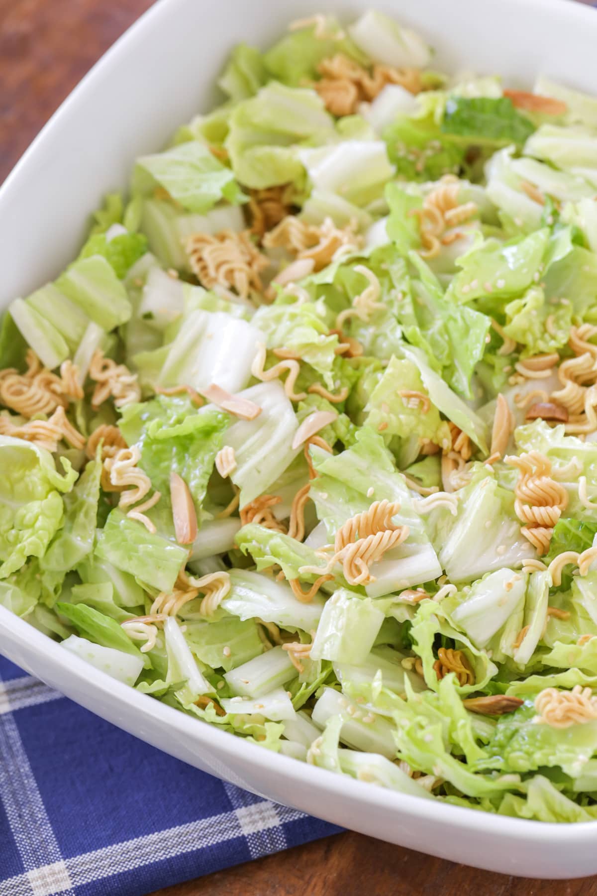 Ramen noodle salad with toasted slivered almonds, ramen noodles and sesame seeds.