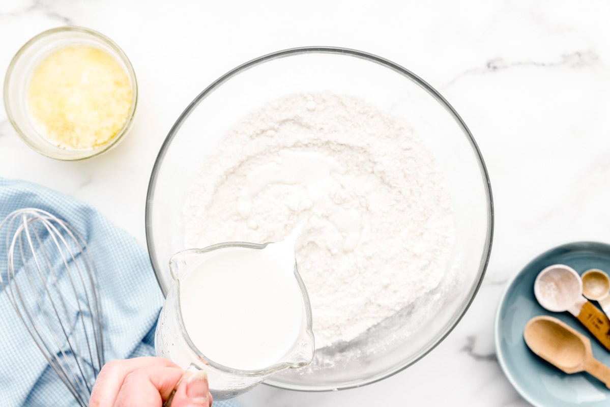 Adding milk to dry ingredients.