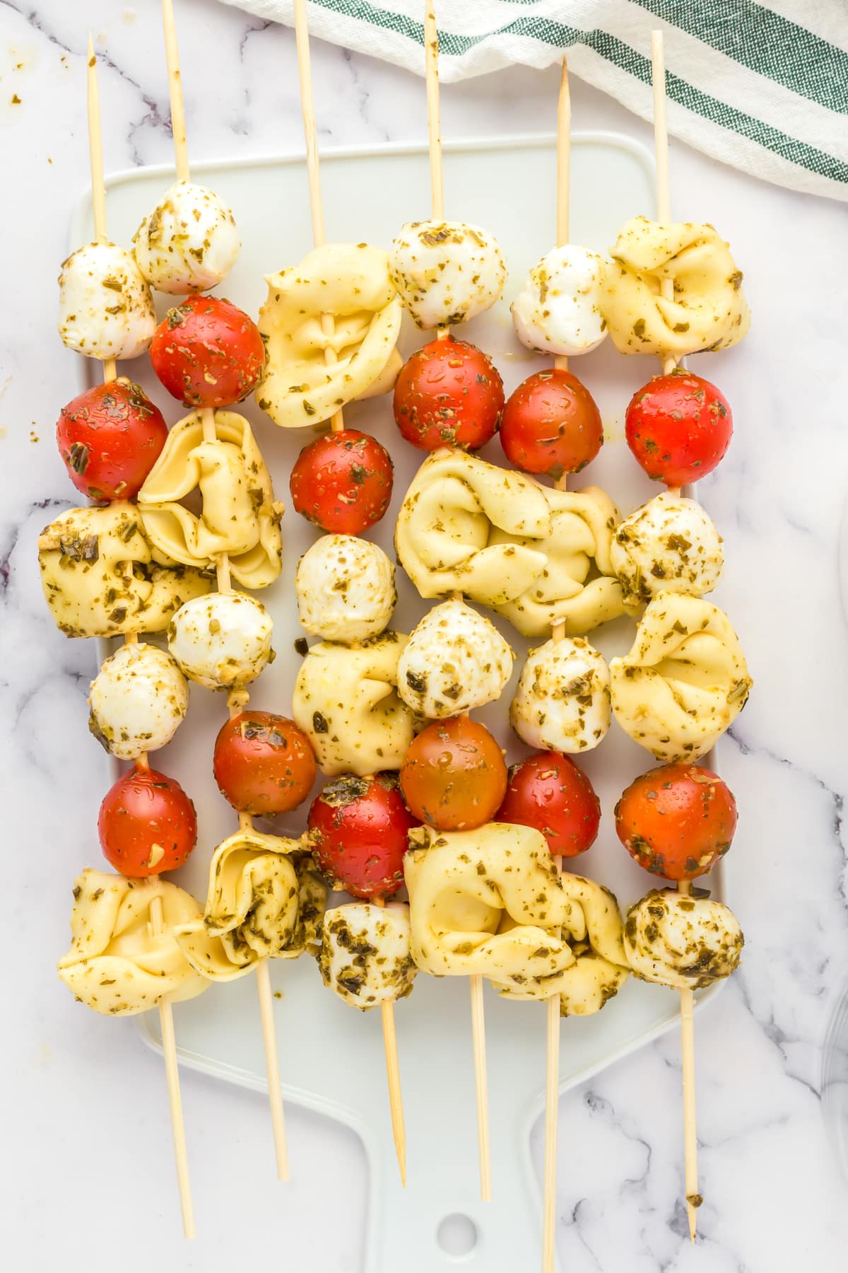 Close up of mozzarella, tomato and tortellini skewers.