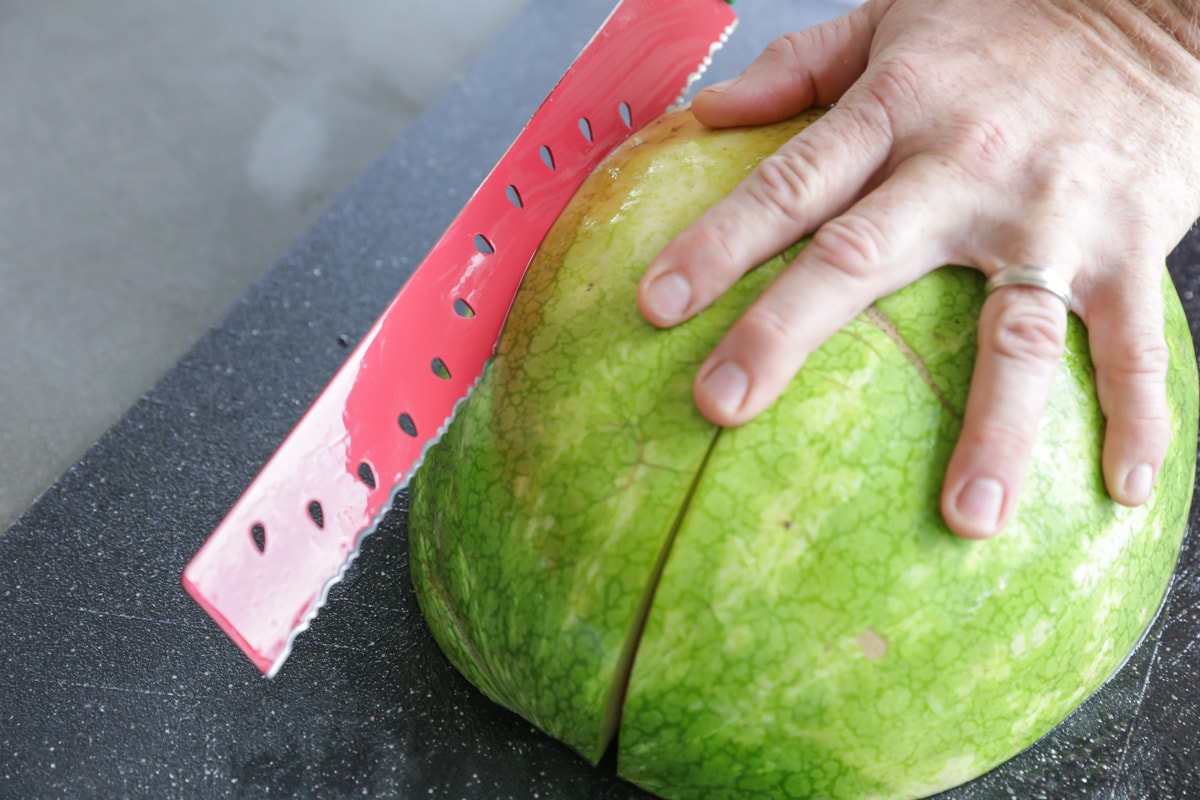 Image showing how to cut a watermelon into quarters.
