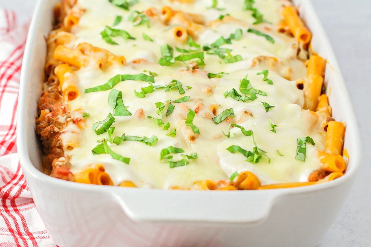 A baked dish filled with easy baked ziti topped with melted mozzarella.