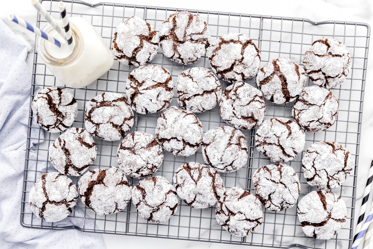 Baked crinkle cookies cooling on a rack.