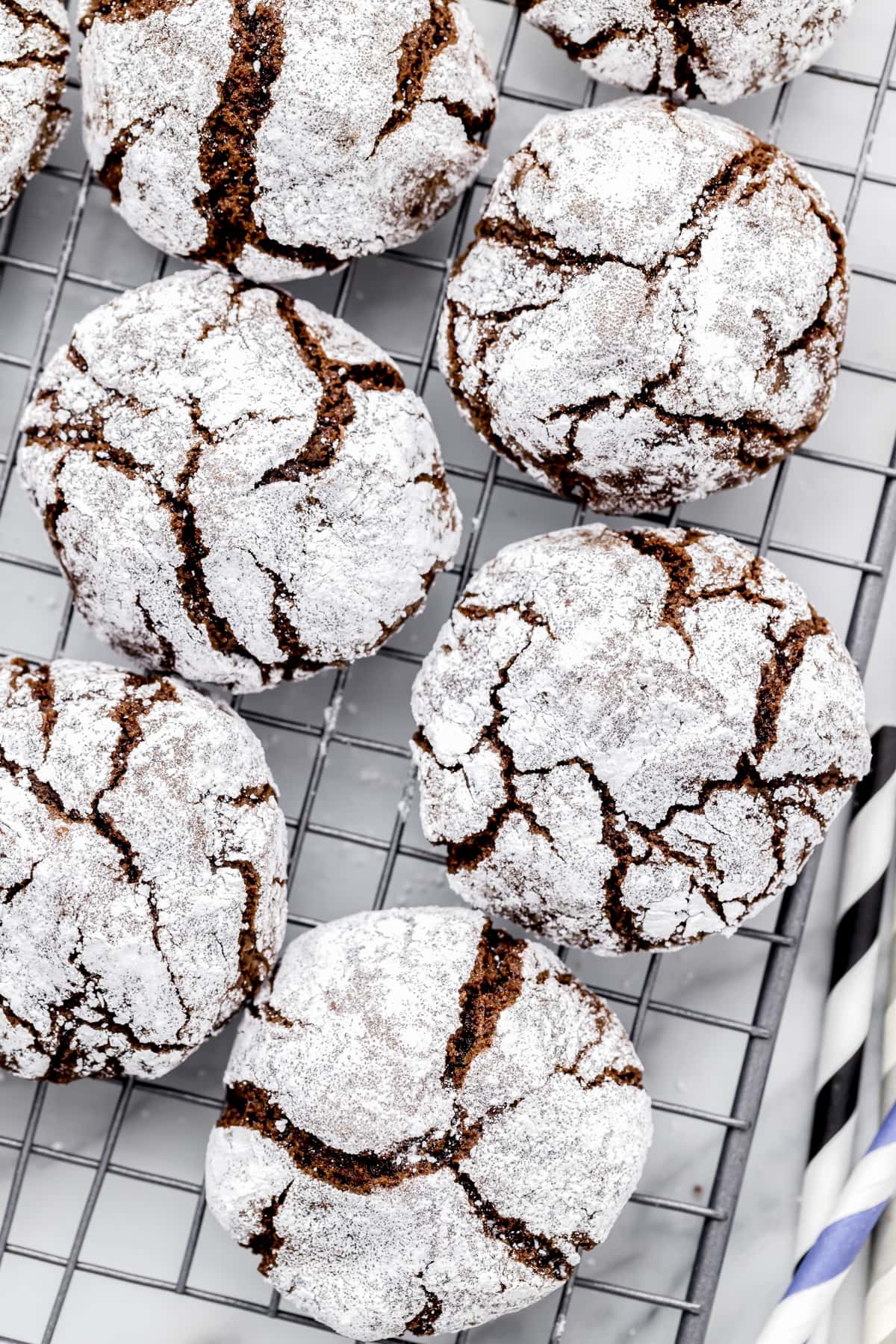 Close up of baked crinkle cookies cooling on a rack.