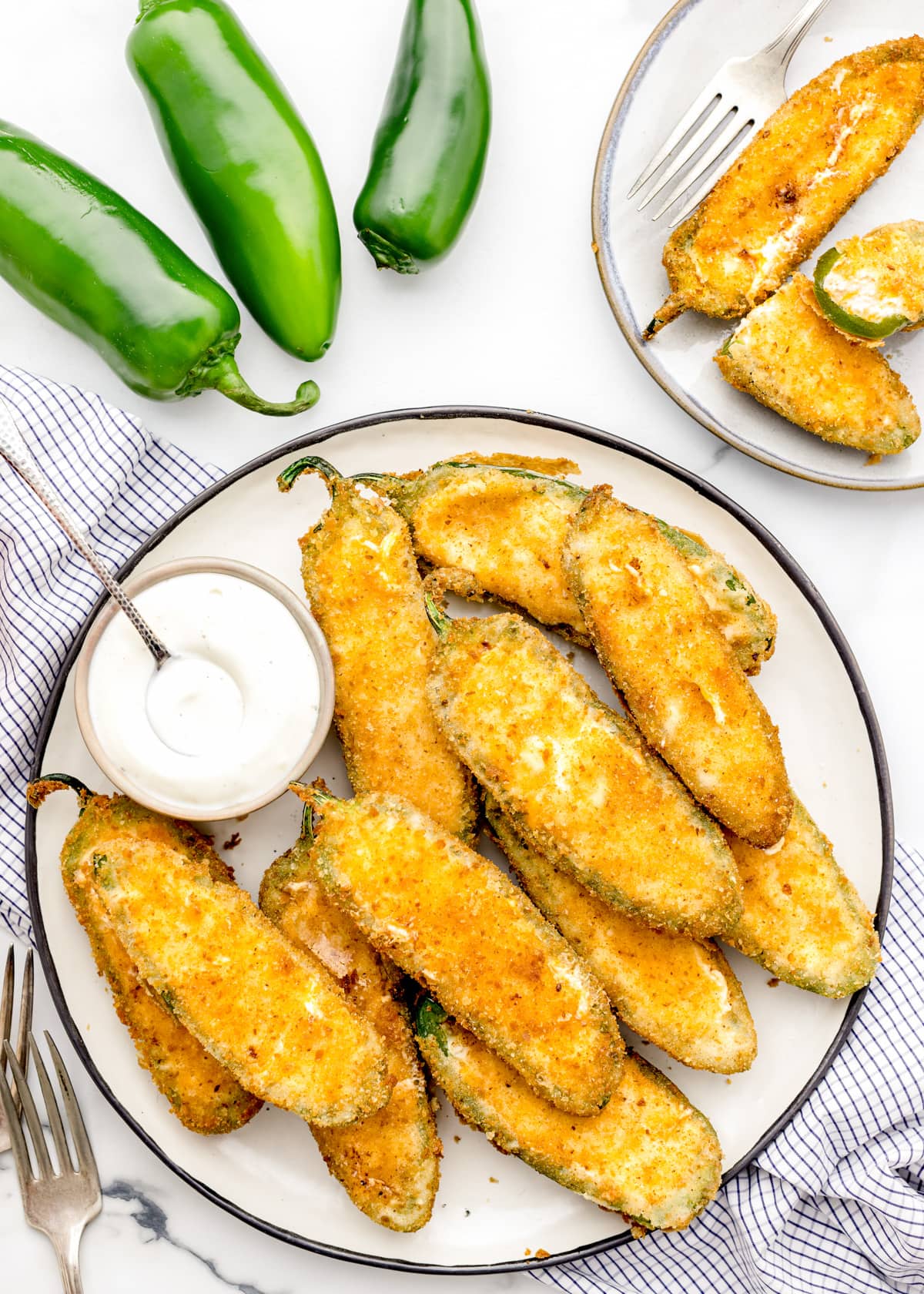A plate of jalapeno poppers served with ranch dressing.