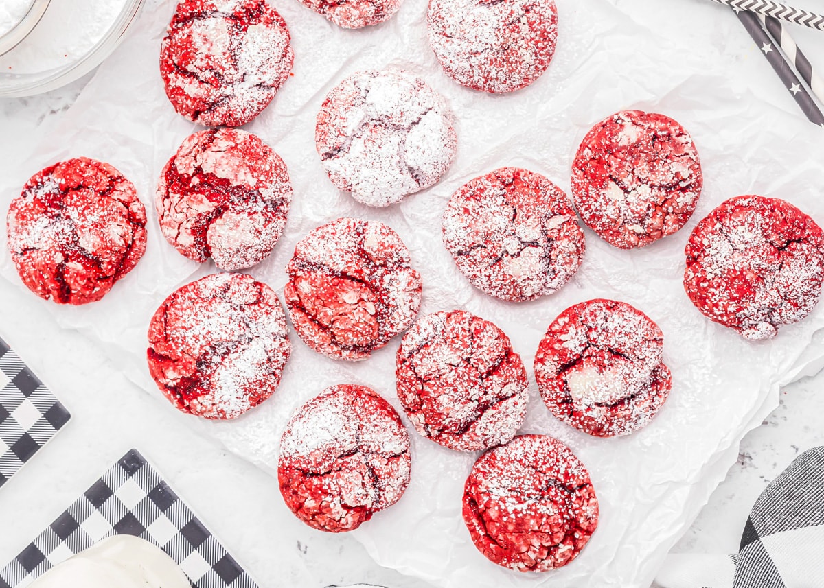 Several red velvet cake mix cookies dusted with powdered sugar.