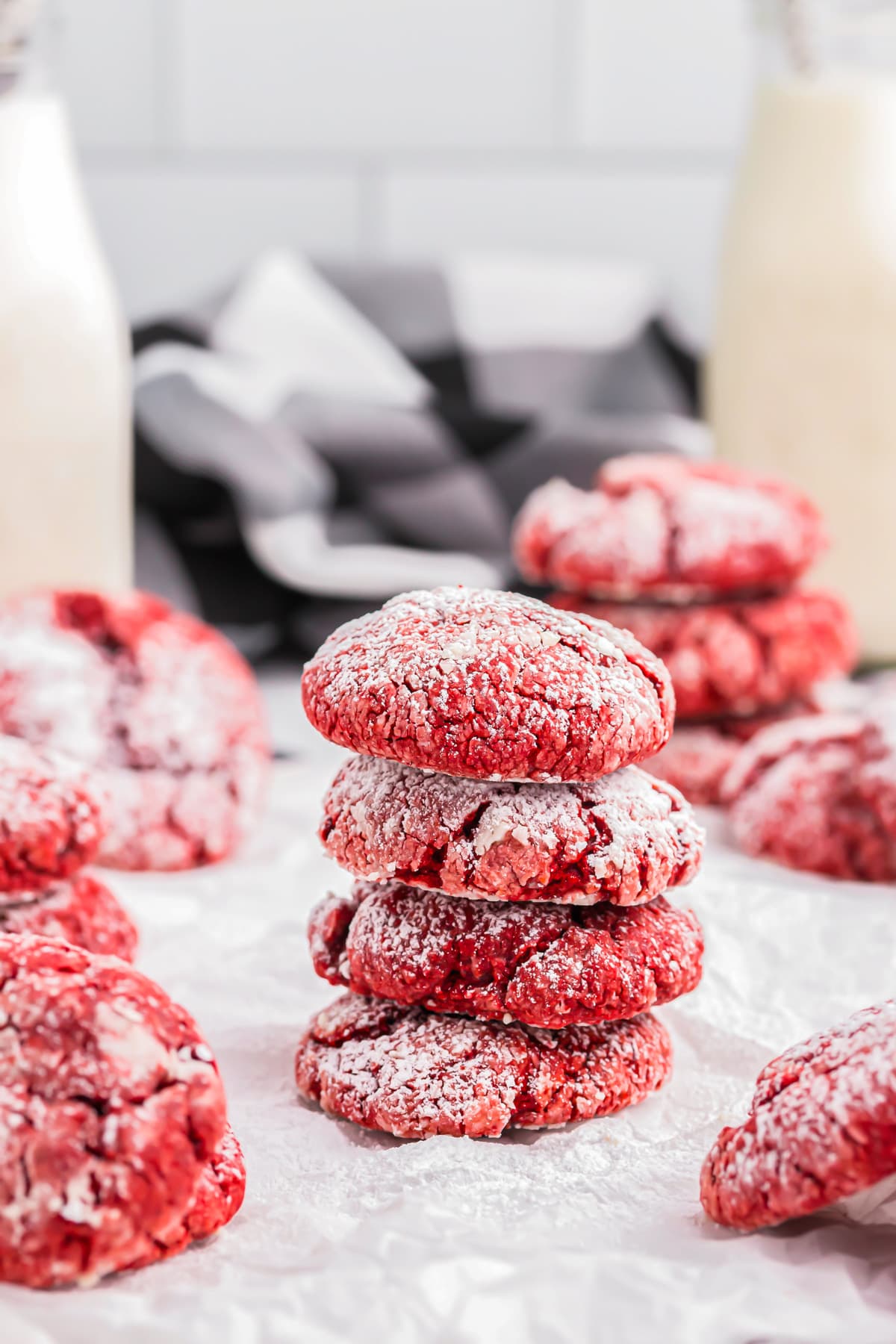 A stack of red velvet cake mix cookies dusted with powdered sugar.