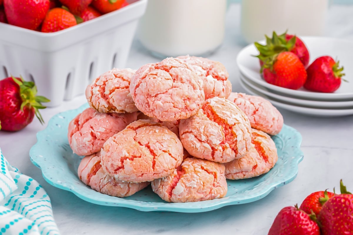 Strawberry cake mix cookies stacked on a blue plate. 