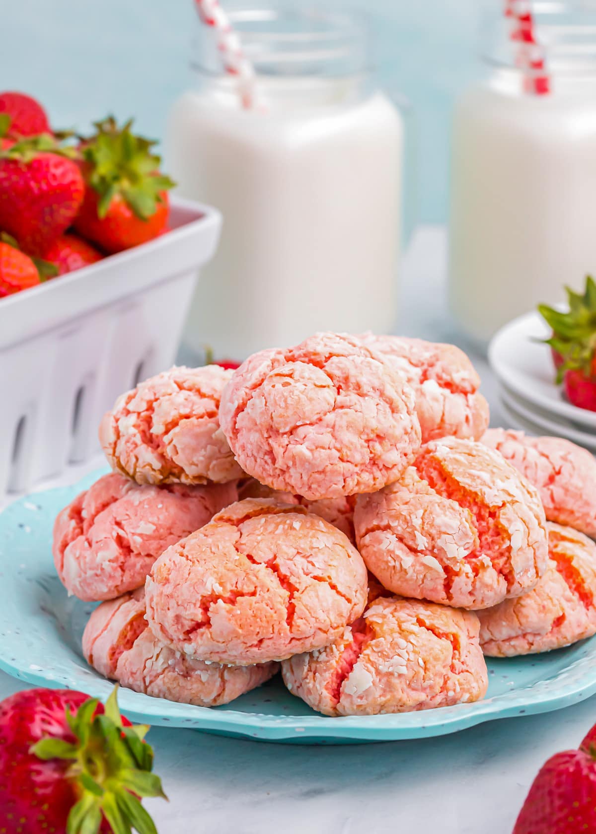 A plate piled high with strawberry cake mix cookies.