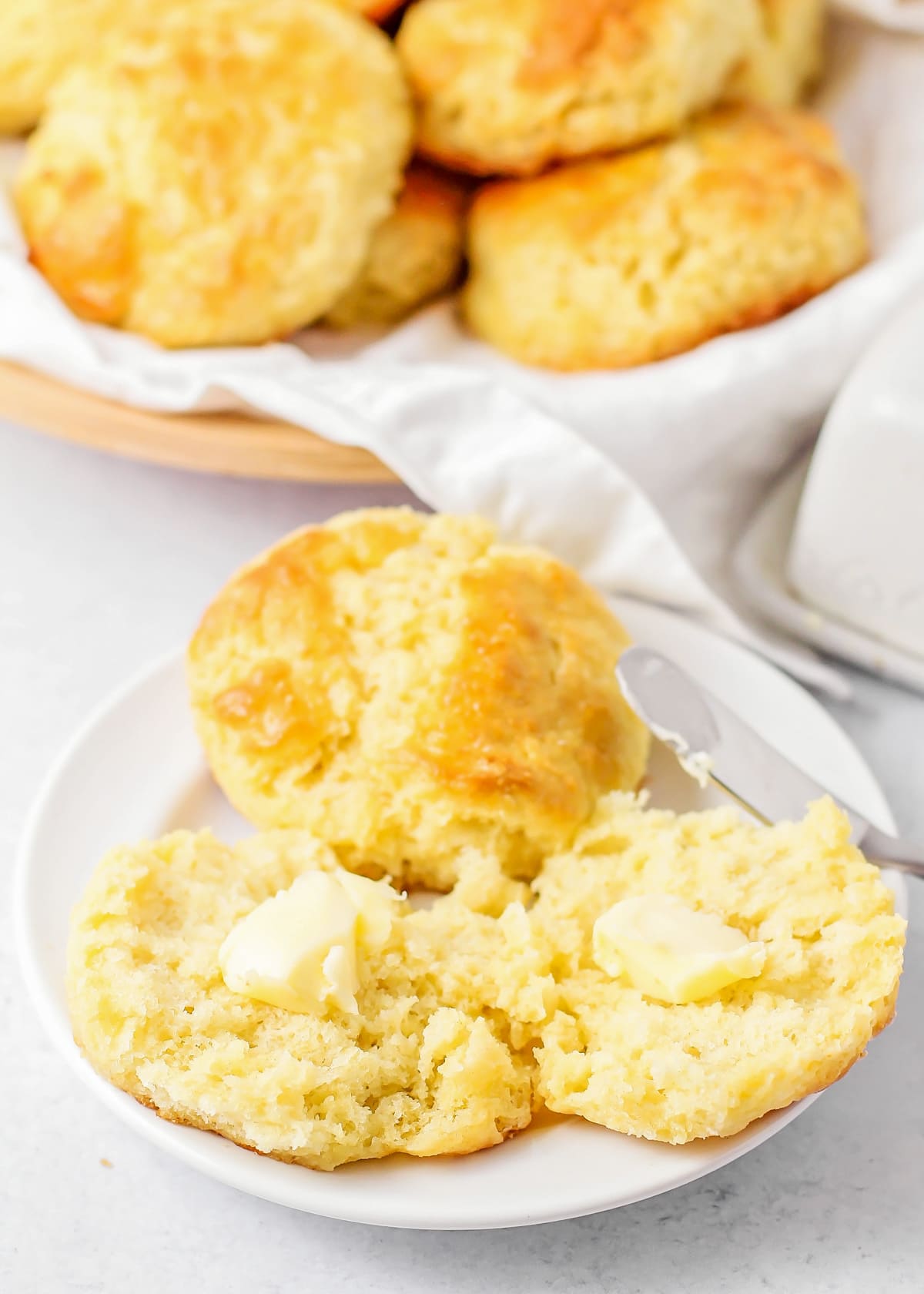 Buttermilk biscuits recipe served on a plate with butter.