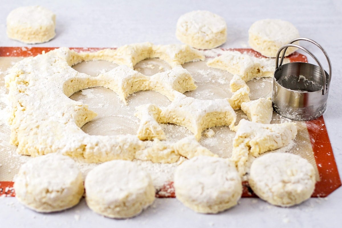 Cutting circle biscuits from rolled out dough.